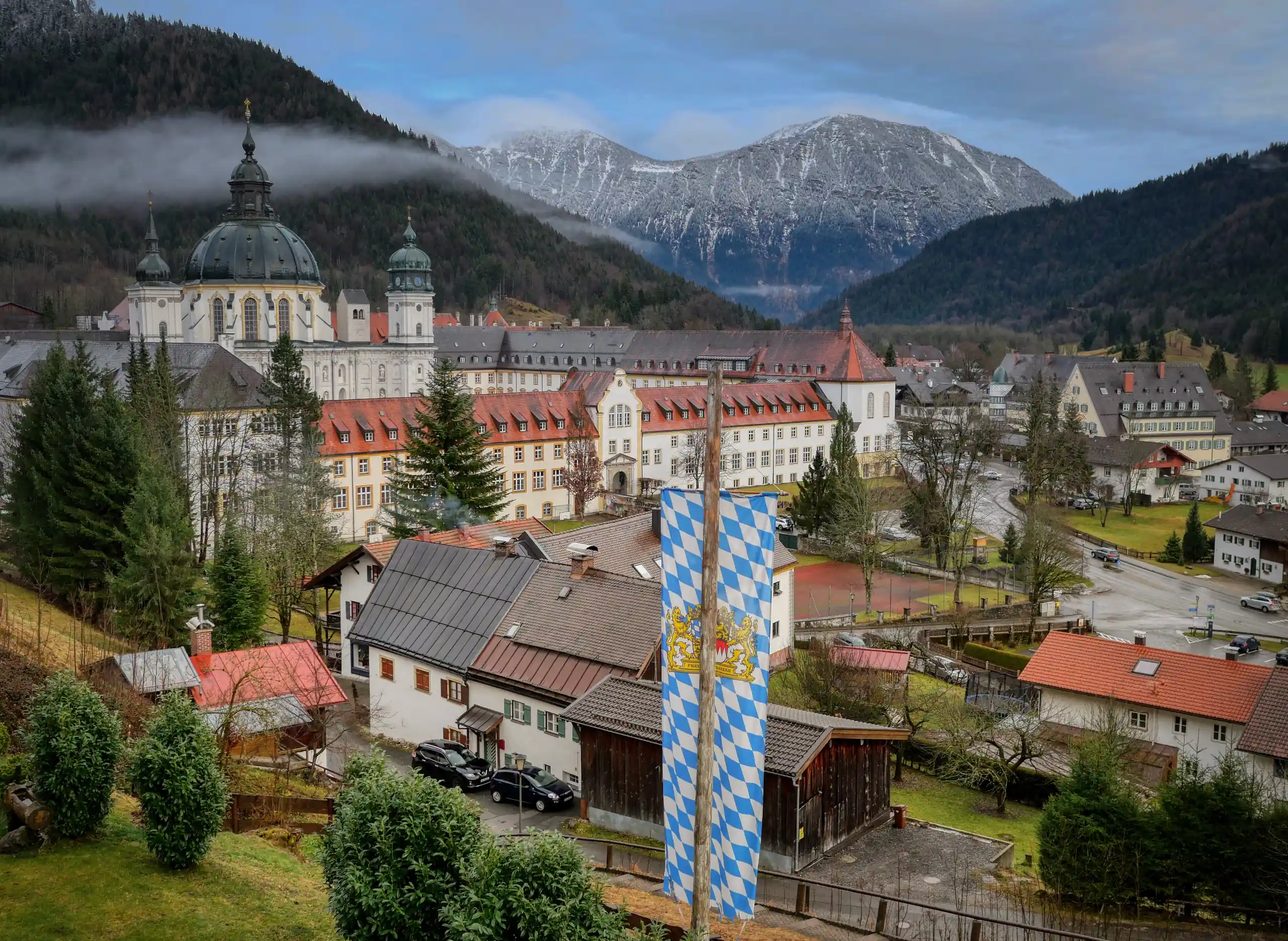 Das Kloster Ettal von der Seite mit Bergen im Hintergrund im heutigen Zustand